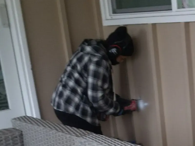 Professional electrician installing an exterior outlet in Olive