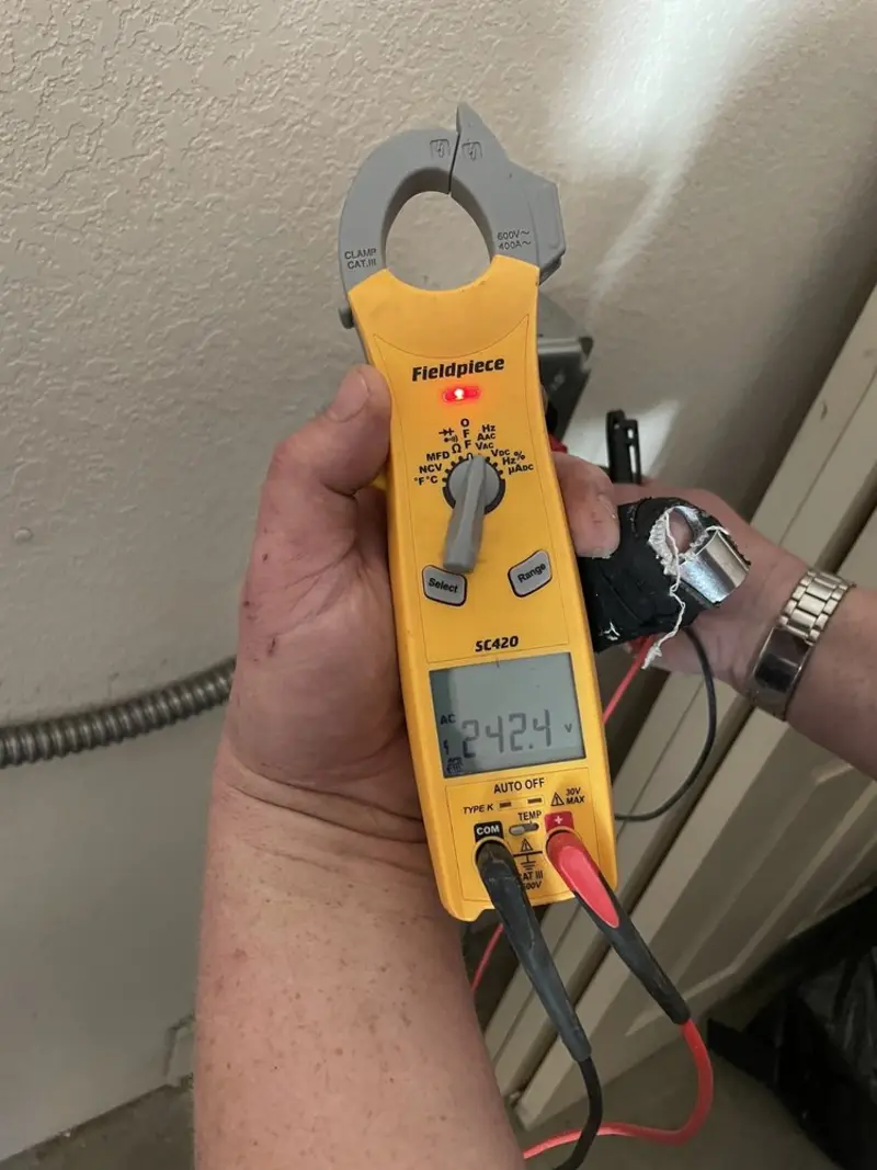 Voltage testing with clamp meter during Recessed Lighting Installation in Olive